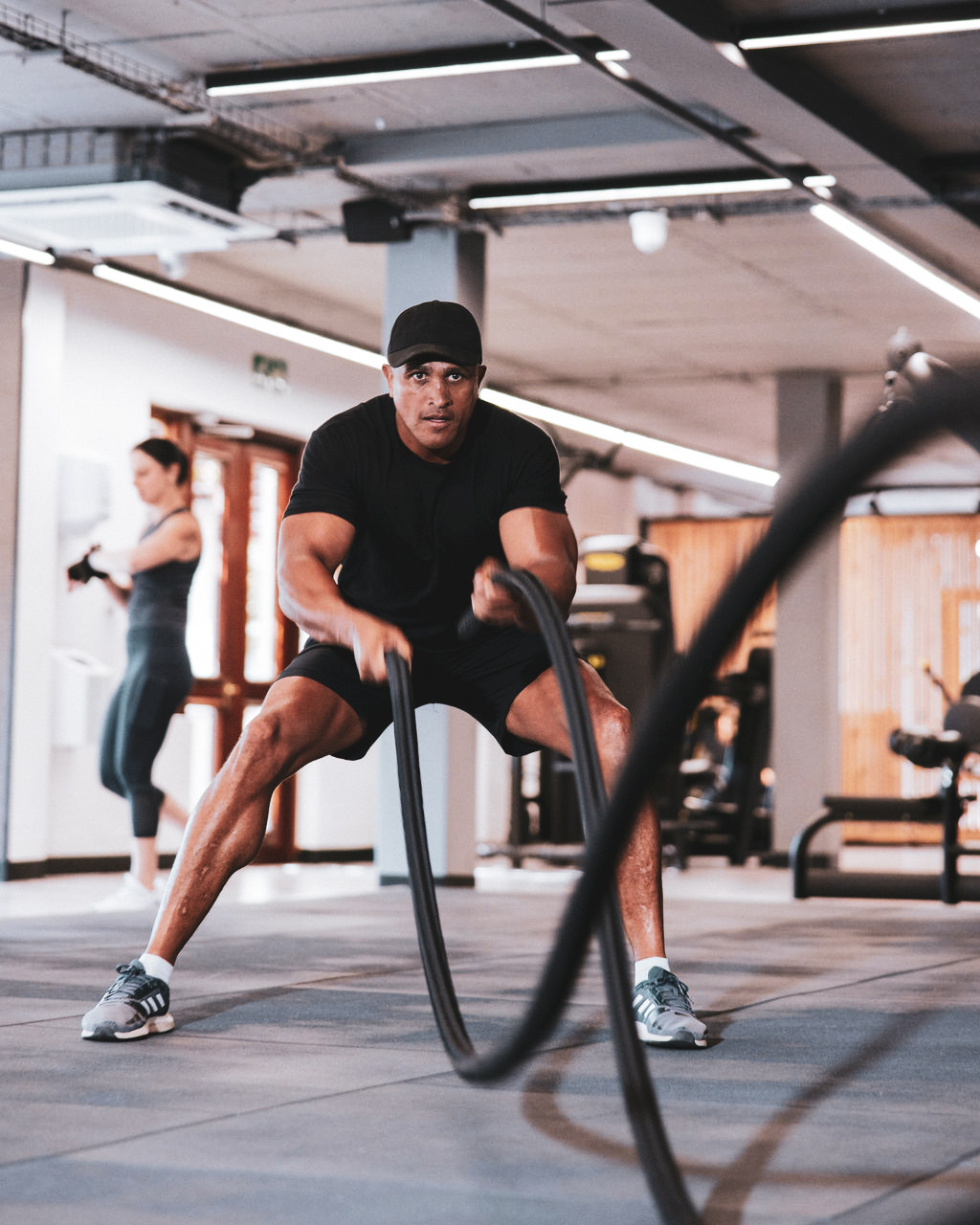 Member training with battle ropes at Aspire Fitness